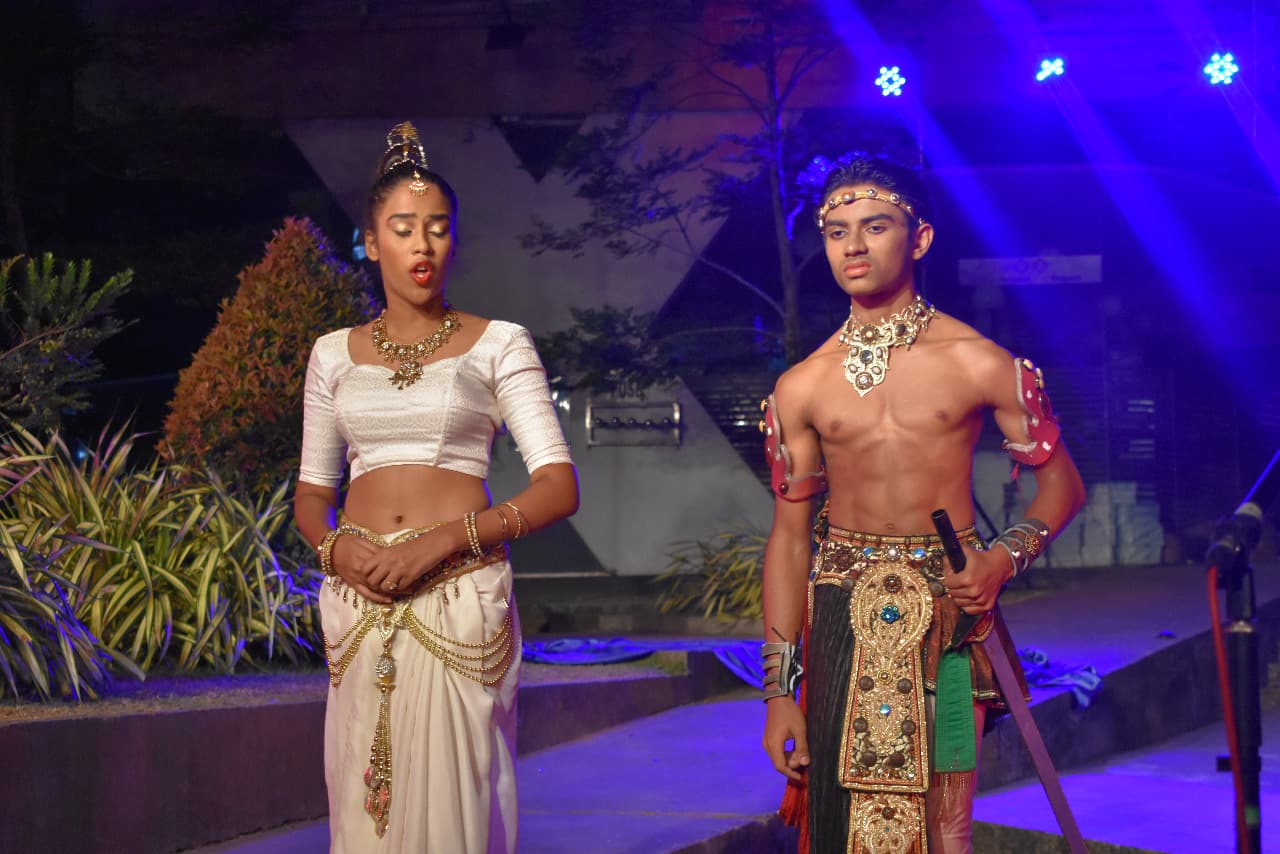 Rian on stage in a high school performance